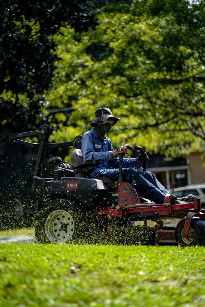 Someone cutting edge of lawn